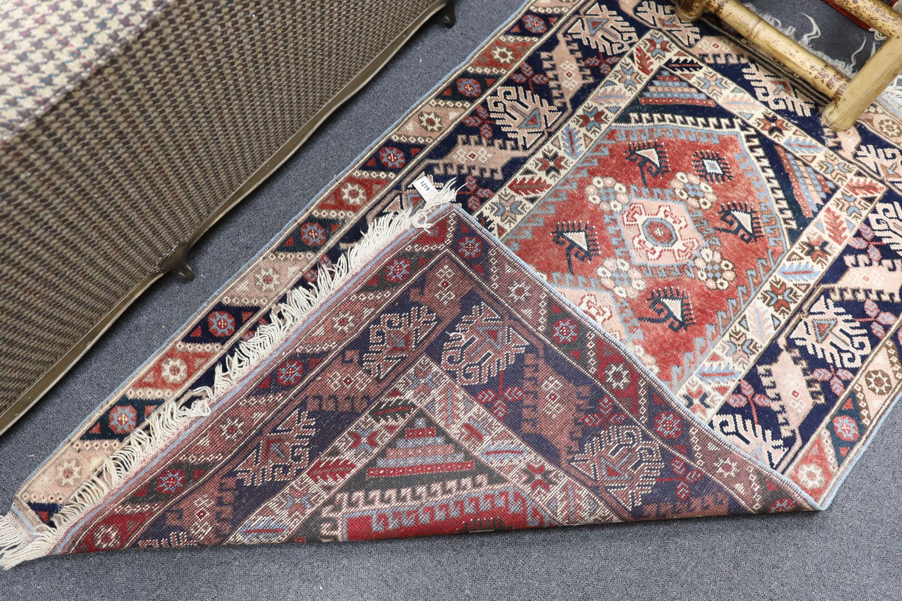 A Caucasian red ground rug and a Bokhara runner, rug 180 x 120 cms